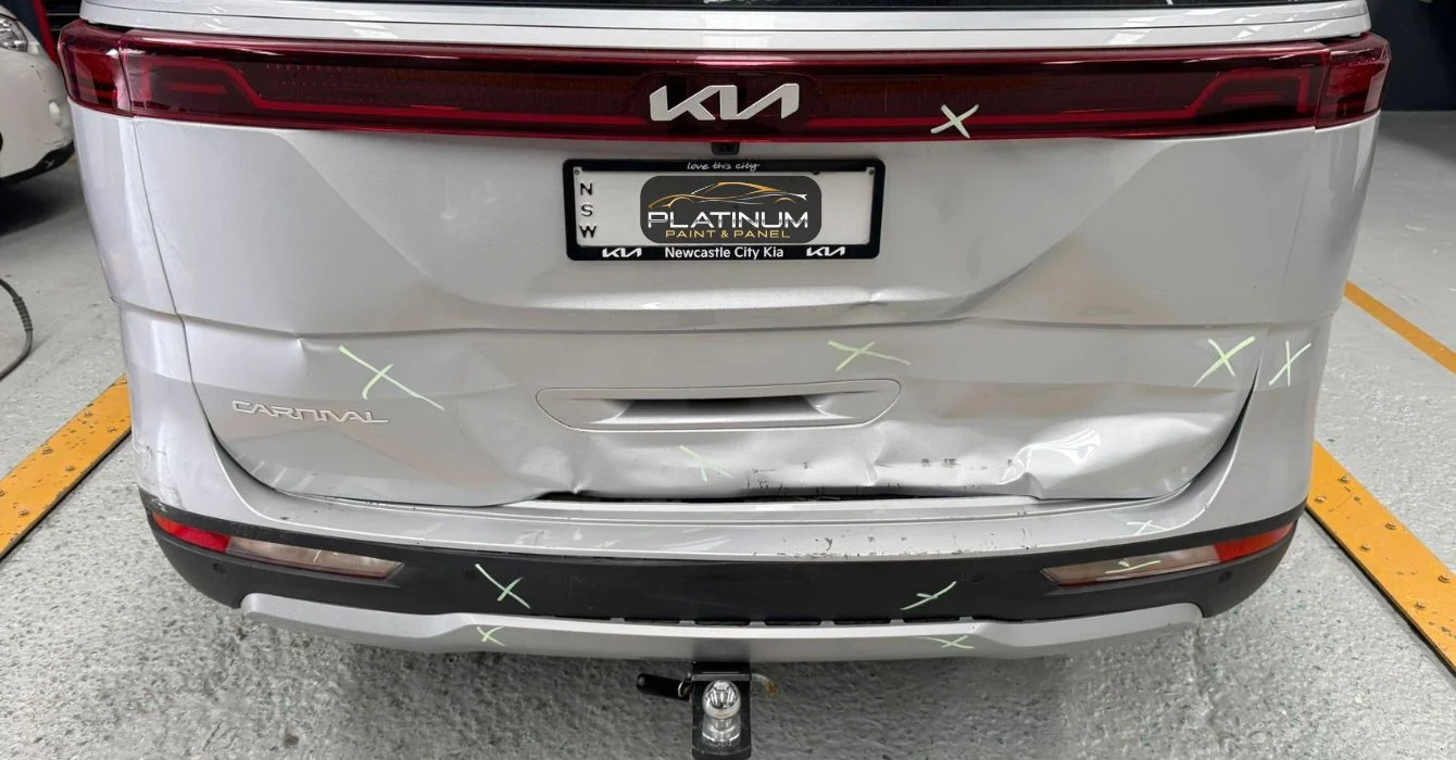 Close-up of a vehicle with a visibly damaged rear bumper and fender, highlighting common smash repair needs.