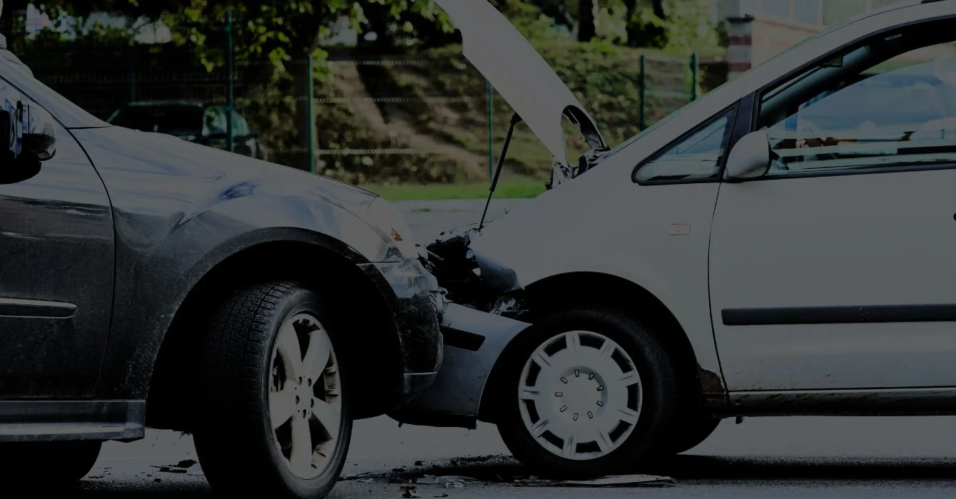 Two damaged vehicles after a collision, showing front-end and side impact, illustrating the severity of smash repairs needed.